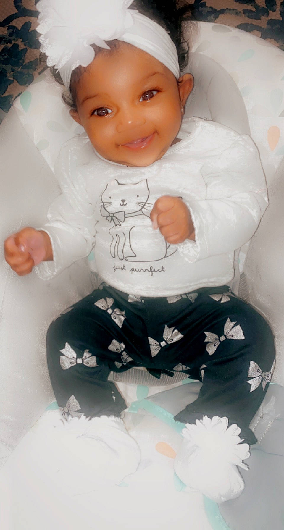 Anilah is registered to the contest to win money with this photo: arm, baby, baby_products, baby_safety, baby_toddler_clothing, cap, cheek, child, gesture, happy, headwear, joy, leg, person, pink, product, sitting, sleeve, smile, textile