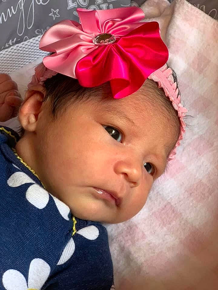 Marjorie is registered to the contest to win money with this photo: baby, baby_toddler_clothing, cheek, child, clothing, ear, fashion_accessory, hair_accessory, head, headband, headgear, headpiece, headwear, lip, person, pink, toddler