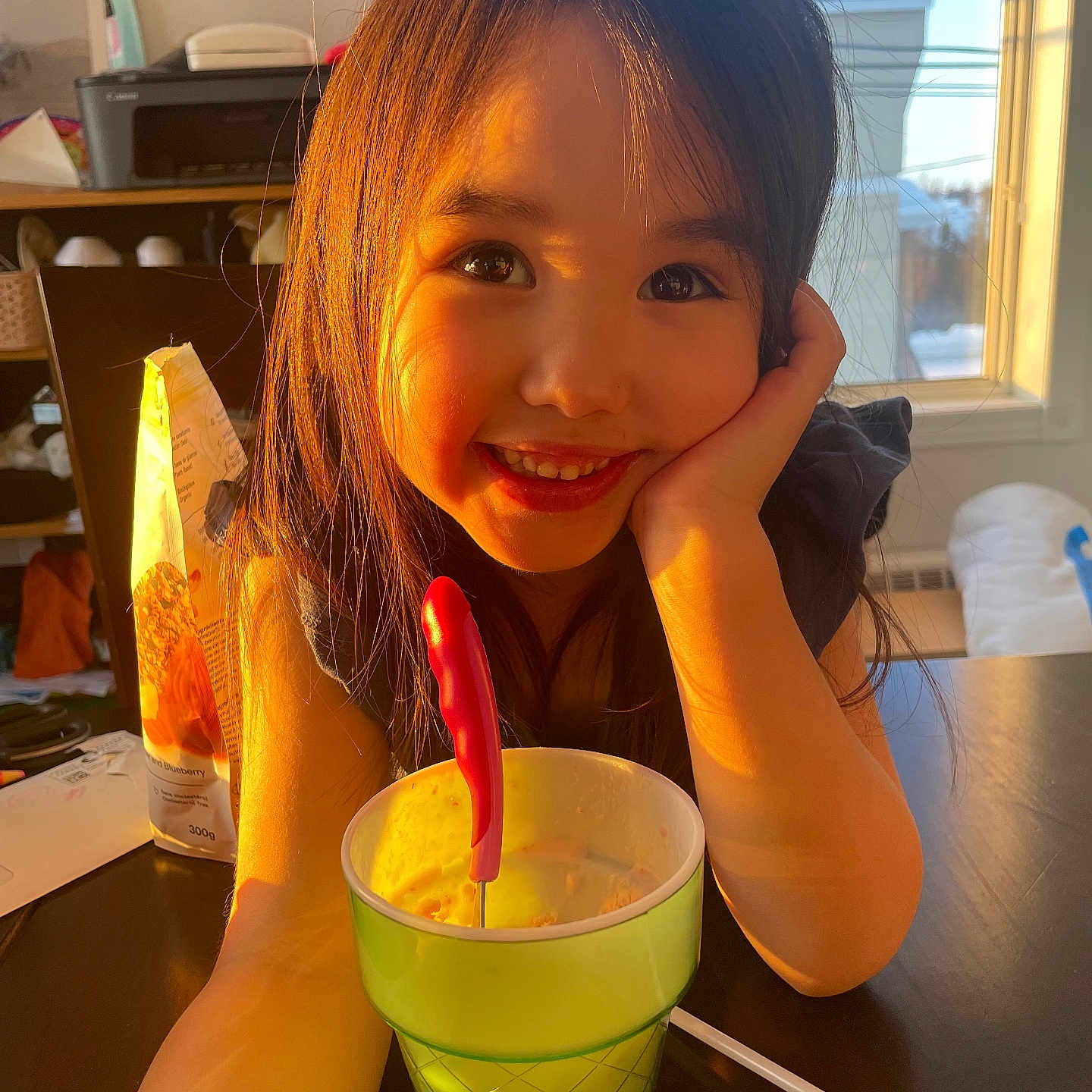 Aviaya is registered to the contest to win money with this photo: beverage, child, cream, cup, cutlery, dessert, face, female, food, furniture, girl, head, icecream, icing, juice, person, photography, portrait, spoon, table