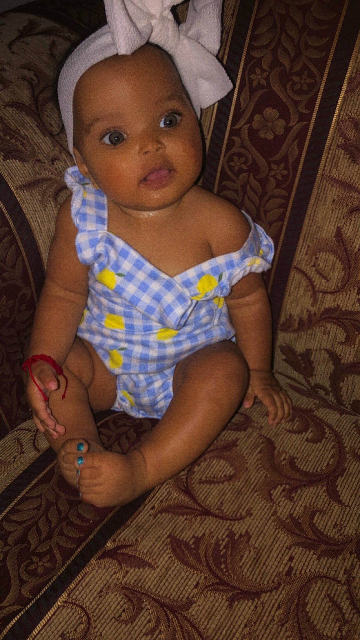 Mary is registered to the contest to win money with this photo: baby, baby_toddler_clothing, cap, cheek, chest, child, chin, dress, electric_blue, eye, flash_photography, hand, human_leg, iris, lip, pattern, person, skin, thigh, toddler