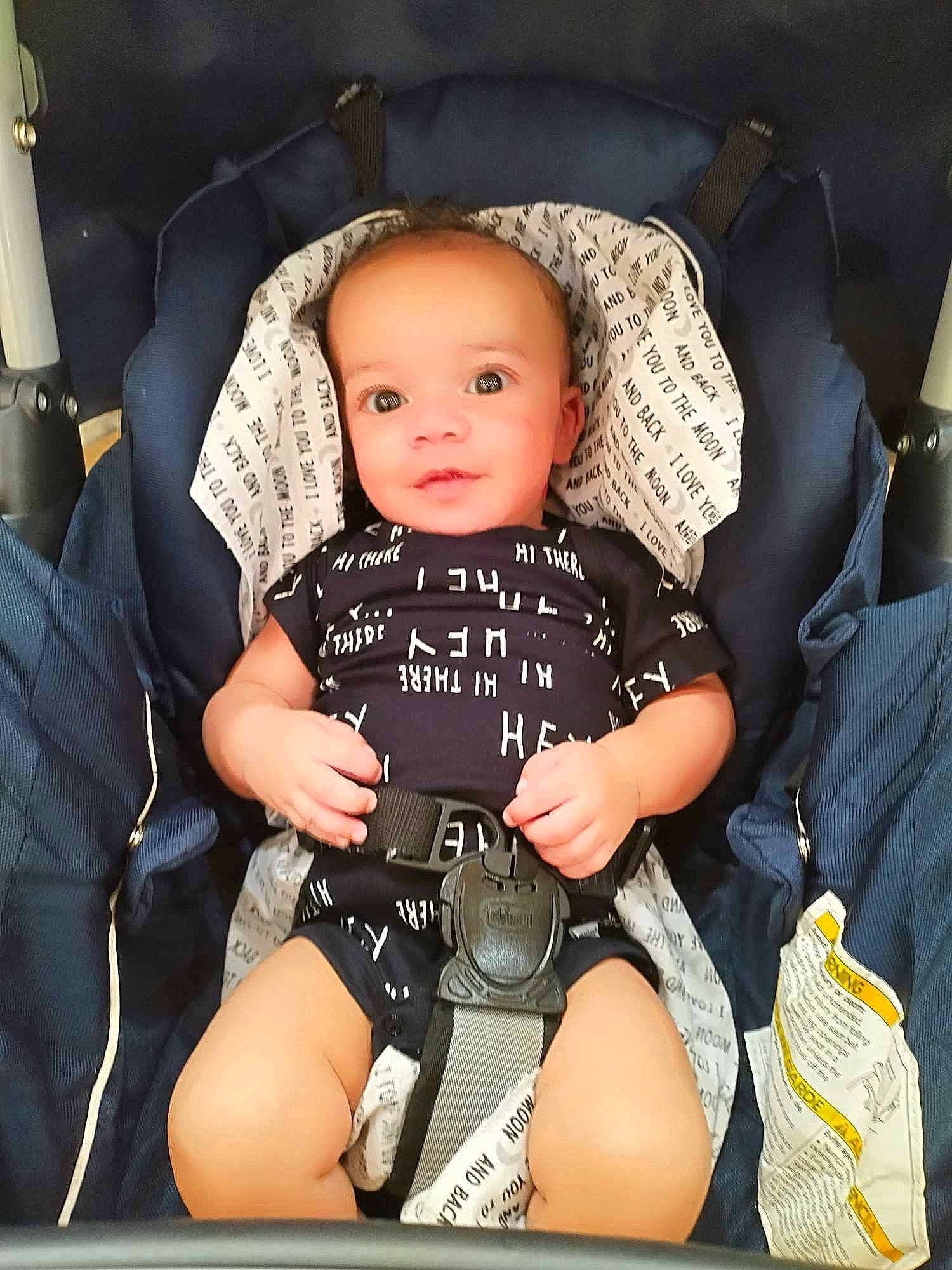 Langston is registered to the contest to win money with this photo: auto_part, baby, baby_carriage, baby_in_car_seat, baby_products, baby_safety, baby_toddler_clothing, car_seat, child, comfort, human_leg, knee, lap, person, personal_protective_equipment, product, sitting, sleeve, smile, thigh