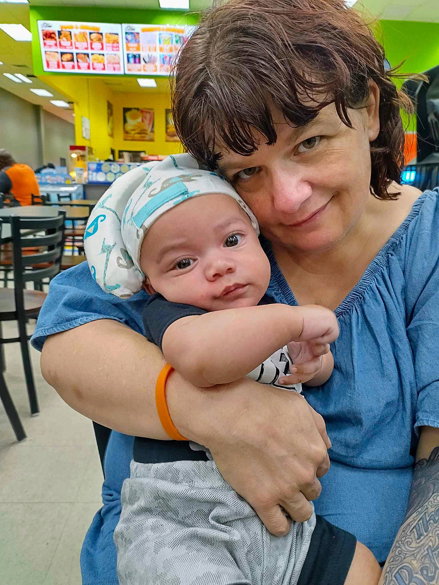 Langston is registered to the contest to win money with this photo: baby, baby_products, chair, child, event, fun, happy, hat, headwear, hug, joy, leisure, person, recreation, service, shorts, sitting, smile, sun_hat, t_shirt