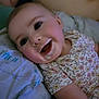 baby, infant, smiling, milk, milk_mustache, floral_clothing, pillow, lying_down, closeup, face, happy, cute, child, indoors, skin, person, expression, young, head, cheeks
