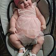Essence joined the competition — help win amazing prizes! baby, child, smiling, pink_dress, headband, bow, sandals, infant, seated, cushion, happy, cute, indoor, soft_lighting, tulle, bare_arms, bare_legs, white, comfortable, adorable