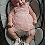 baby, child, smiling, pink_dress, headband, bow, sandals, infant, seated, cushion, happy, cute, indoor, soft_lighting, tulle, bare_arms, bare_legs, white, comfortable, adorable