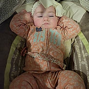 Essence is registered to the contest to win money with this photo: baby, baby_seat, bow, child, cozy, cushion, cute, floral_pattern, headband, indoors, infant, onesie, pacifier, peaceful, pink, portrait, relaxing, sleeping, soft_lighting, white