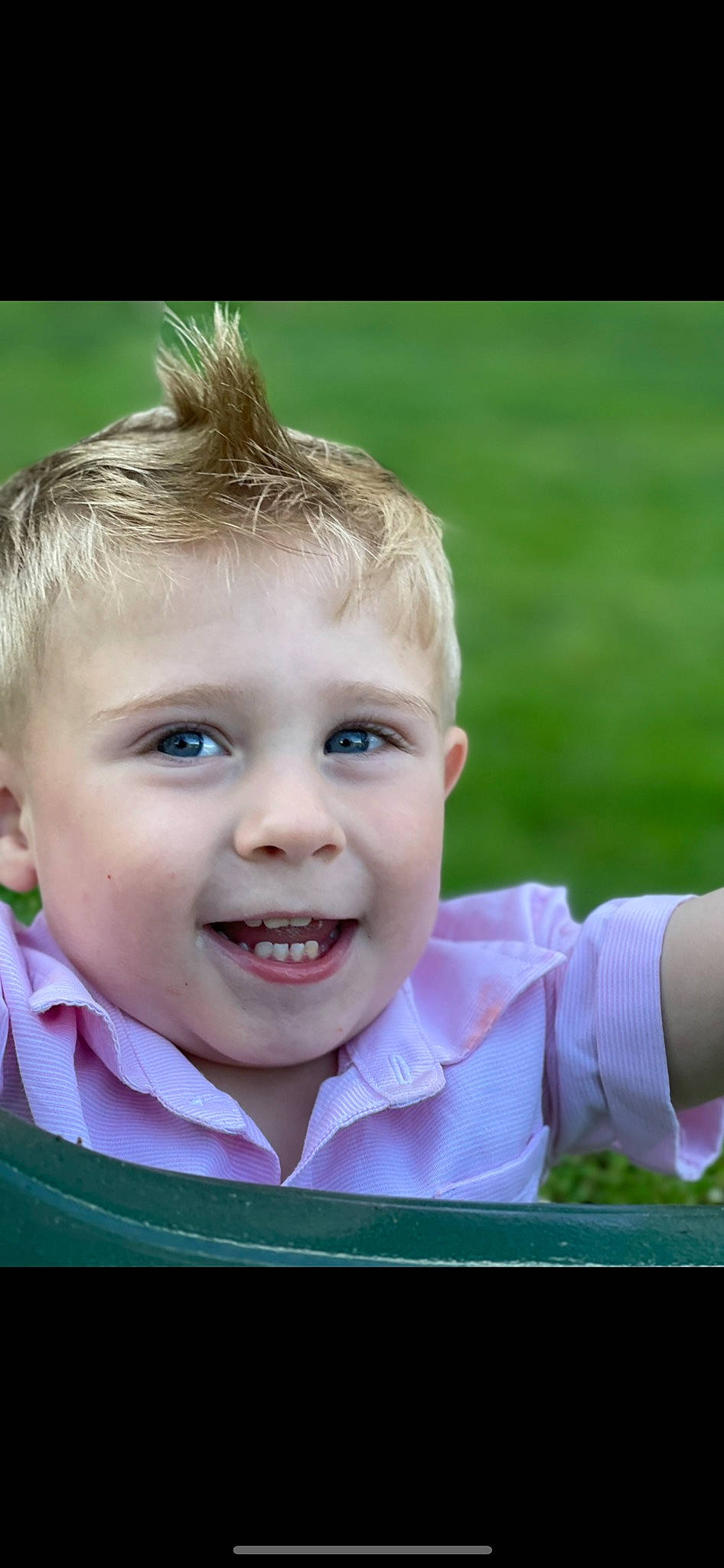 Bentley is registered to the contest to win money with this photo: cheek, chin, eye, face, facial_expression, flash_photography, gesture, grass, happy, human_body, iris, lip, nose, people_in_nature, person, plant, skin, smile, toddler, tooth