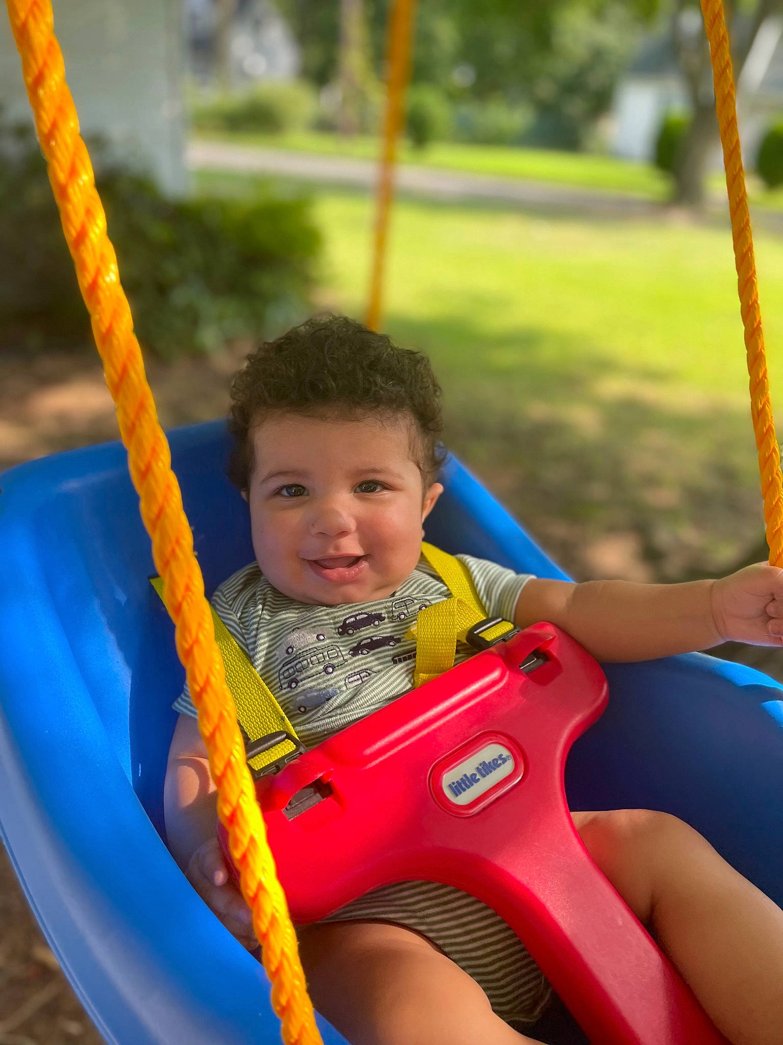 Corbyn is registered to the contest to win money with this photo: black, city, fun, grass, happy, joy, leisure, light, outdoor_play_equipment, outdoor_recreation, people, person, photograph, playground, product, recreation, red, summer, swing, toddler