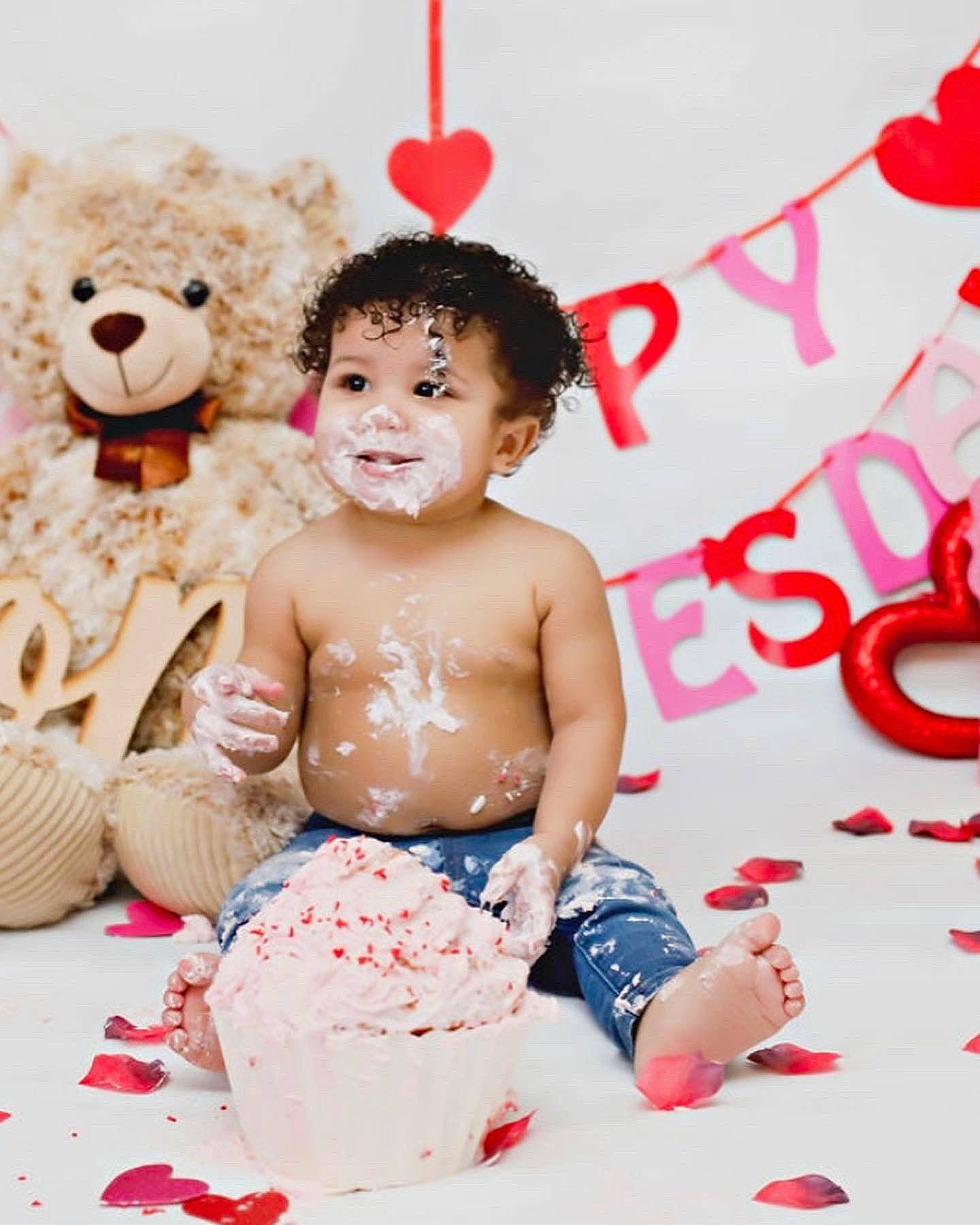 Corbyn is registered to the contest to win money with this photo: baby, cake, child, event, food, fun, happy, icing, ingredient, person, pink, recipe, red, skin, smile, sugar_cake, sweetness, teddy_bear, toddler, toy
