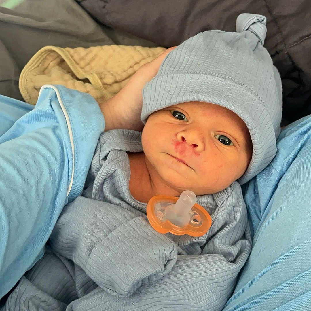 Colt joined the competition — help win amazing prizes! architecture, baby, bed, blanket, building, cap, clothing, couch, cushion, face, furniture, hat, head, homedecor, hospital, newborn, pants, person, photography, portrait