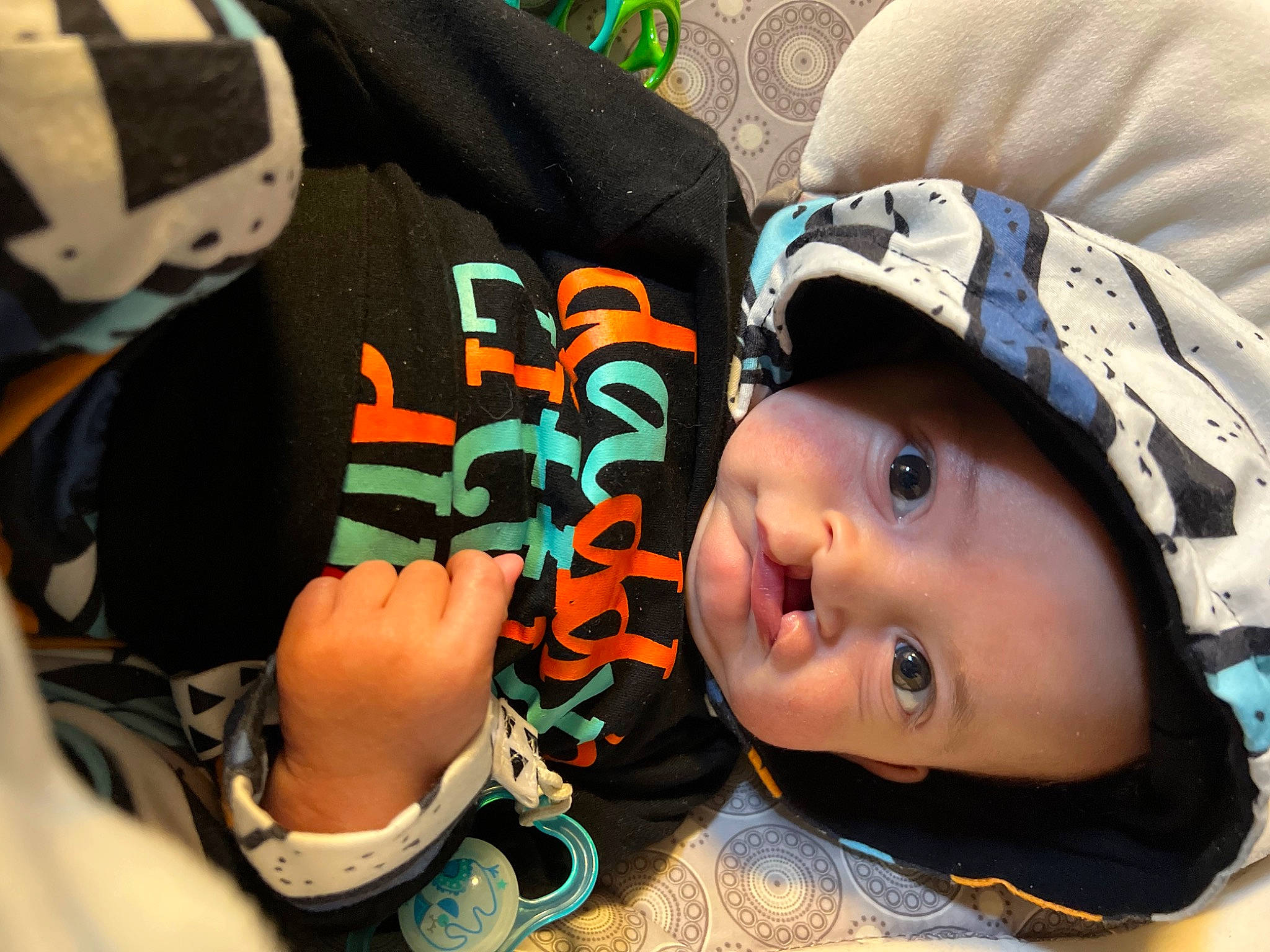 Ezrah is registered to the contest to win money with this photo: baby, baby_toddler_clothing, baseball_cap, beanie, cap, car_seat, cheek, child, fashion_accessory, fun, happy, hat, headgear, headwear, person, personal_protective_equipment, sleeve, toddler