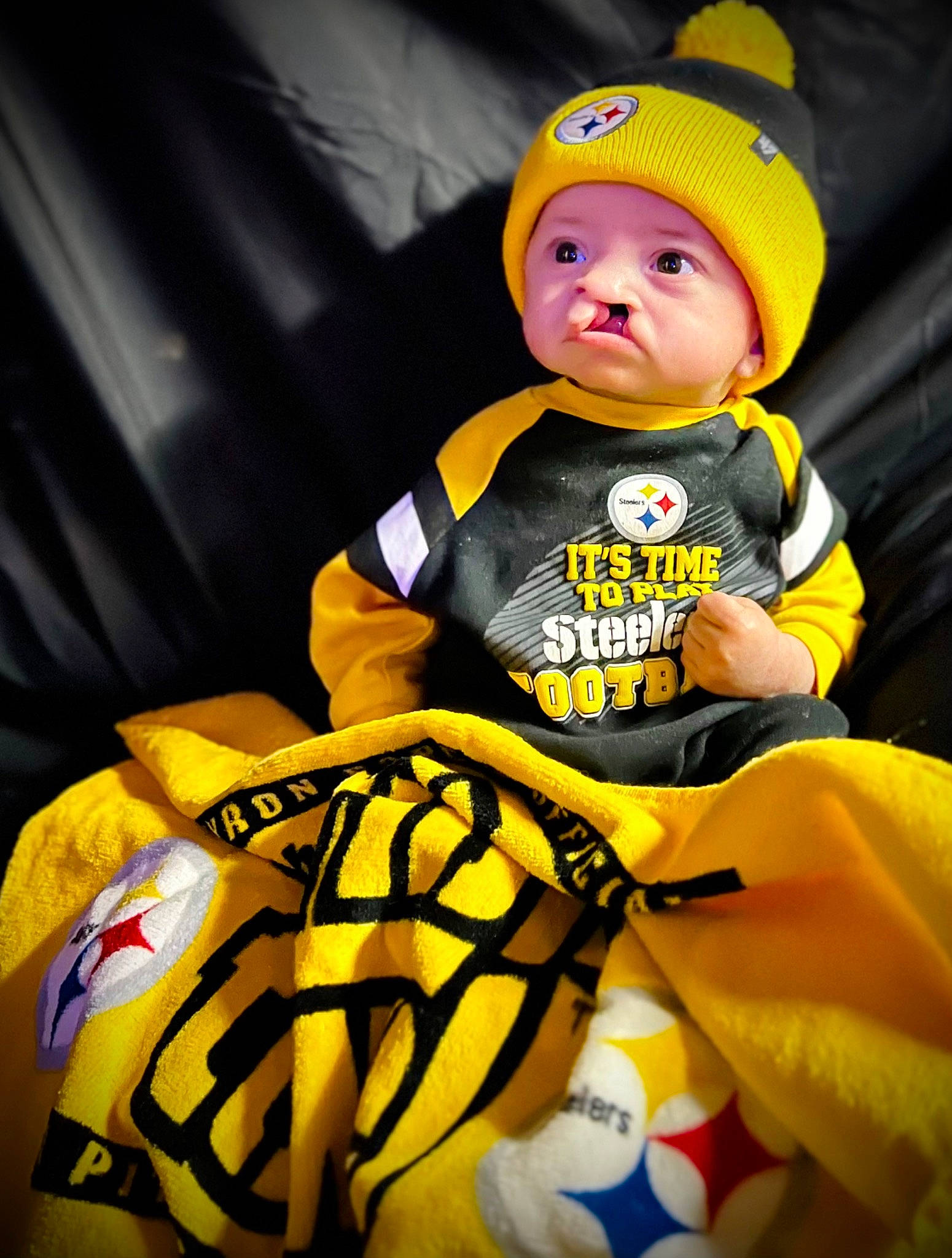 Ezrah joined the competition — help win amazing prizes! baby, baby_products, baby_toddler_clothing, beanie, cap, child, costume_hat, fashion_accessory, fun, happy, hat, headgear, headwear, person, personal_protective_equipment, shorts, sitting, sleeve, sportswear, t_shirt