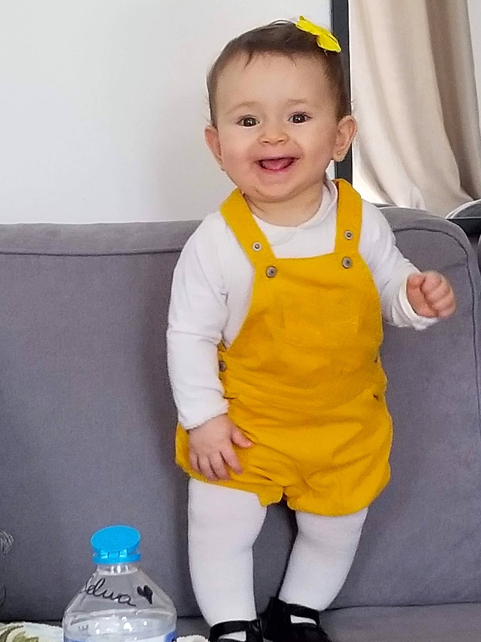 Lyne participe au concours pour gagner de l'argent avec cette photo : baby, baby_toddler_clothing, bottle, bottled_water, child, clothing, dress, drinking_water, eye, face, facial_expression, happy, joy, person, plastic_bottle, product, sleeve, smile, standing, toddler