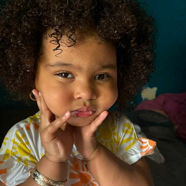 Arabella is registered to the contest to win money with this photo: accessories, biting, blackhair, bracelet, child, curlyhair, dimples, face, female, girl, hair, happy, head, jewelry, person, photography, portrait, smile, surprised