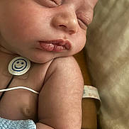 Joesph is registered to the contest to win money with this photo: newborn, baby, sleeping, infant, closeup, skin, face, arm, hospital, monitoring_patch, wristband, blanket, peaceful, cute, child, human, healthcare, soft, rest, tired
