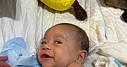 Joesph joined the competition — help win amazing prizes! baby, infant, smile, plush_toy, pineapple, heart, blanket, quilt, bed, indoor, child, happy, cute, soft_toy, person, skin, clothing, fabric, comfort, playful