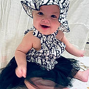 Willow joined the competition — help win amazing prizes! baby, child, smiling, hat, black_and_white, tutu, dress, sitting, cute, happy, infant, fashion, portrait, indoors, blanket, face, person, young_child, headwear, apparel