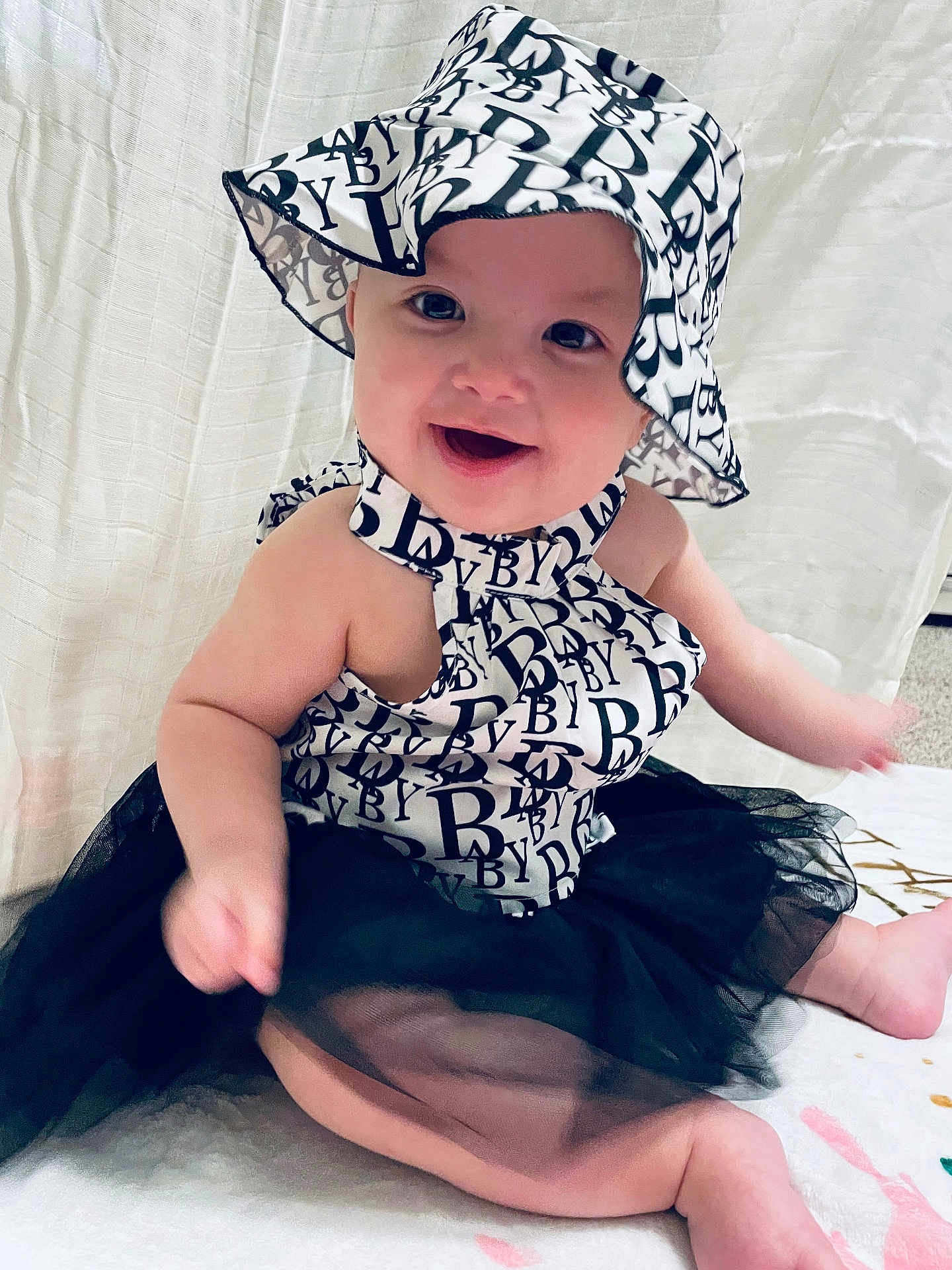 Willow joined the competition — help win amazing prizes! baby, child, smiling, hat, black_and_white, tutu, dress, sitting, cute, happy, infant, fashion, portrait, indoors, blanket, face, person, young_child, headwear, apparel