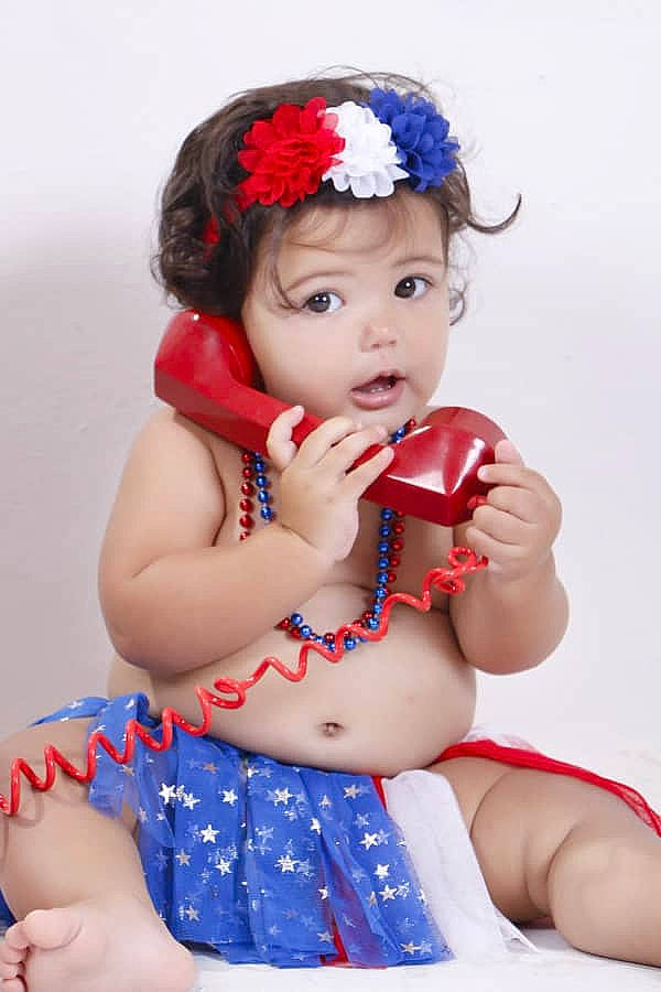 Amy is registered to the contest to win money with this photo: baby, child, child_model, fashion_accessory, finger, hair_accessory, headband, headgear, headpiece, person, photo_shoot, photography, red, toddler