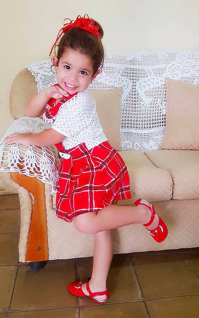 Angeline Krishna is registered to the contest to win money with this photo: baby_toddler_clothing, child, child_model, clothing, costume, dress, human_leg, joy, leg, pattern, person, pink, red, shoe, sitting, skin, textile, thigh, toddler