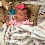 Athena Rose is registered to the contest to win money with this photo: baby, blanket, child, cozy, cushion, cute, headband, indoors, infant, newborn, pacifier, peaceful, pink_bow, plush_toy, portrait, resting, sleeping, soft_texture, star_pattern, warm