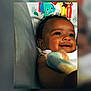 Gracie is registered to the contest to win money with this photo: baby, smiling, infant, blanket, cute, child, face, portrait, indoors, colorful, cartoon, soft, happy, closeup, young, skin, eyes, expression, comfort, warmth