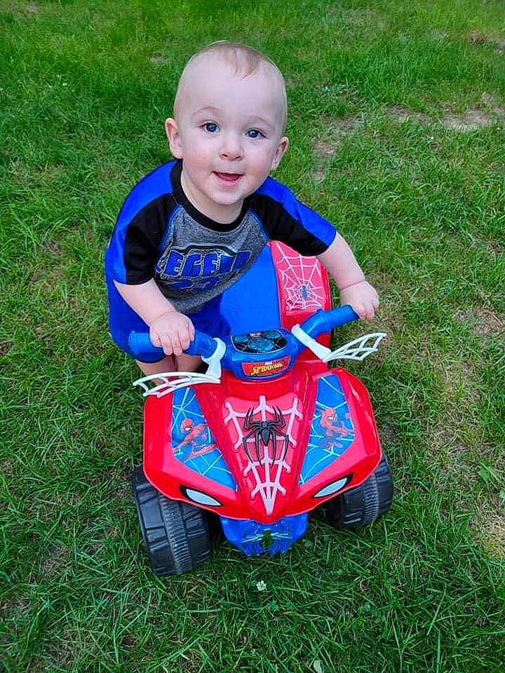 Landen joined the competition — help win amazing prizes! automotive_tire, automotive_wheel_system, baby, baby_toddler_clothing, child, electric_blue, grass, grass_family, grassland, happy, human_body, lawn, person, recreation, riding_toy, smile, tire, toddler, toy, vehicle