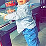 Maëlio a rejoint le concours — aidez-le/la à gagner de superbes lots ! blue_eyes, candies, child, curious, cute, furniture, glass_table, home, indoor, jar, jeans, living_room, person, portrait, socks, standing, striped_shirt, tile_floor, toddler, toy