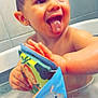 Maëlio participe au concours pour gagner de l'argent avec cette photo : toddler, bath, bathtub, child, wet, smiling, tongue_out, toy, book, animal_illustration, happy, indoors, water, foam, skin, face, hand, playful, cute, bath_time