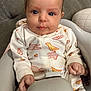 Haisley is registered to the contest to win money with this photo: baby, infant, high_chair, onesie, animal_print, cute, child, indoor, seated, hands, face, eyes, expression, clothing, young_child, adorable, portrait, person, comfort, smile