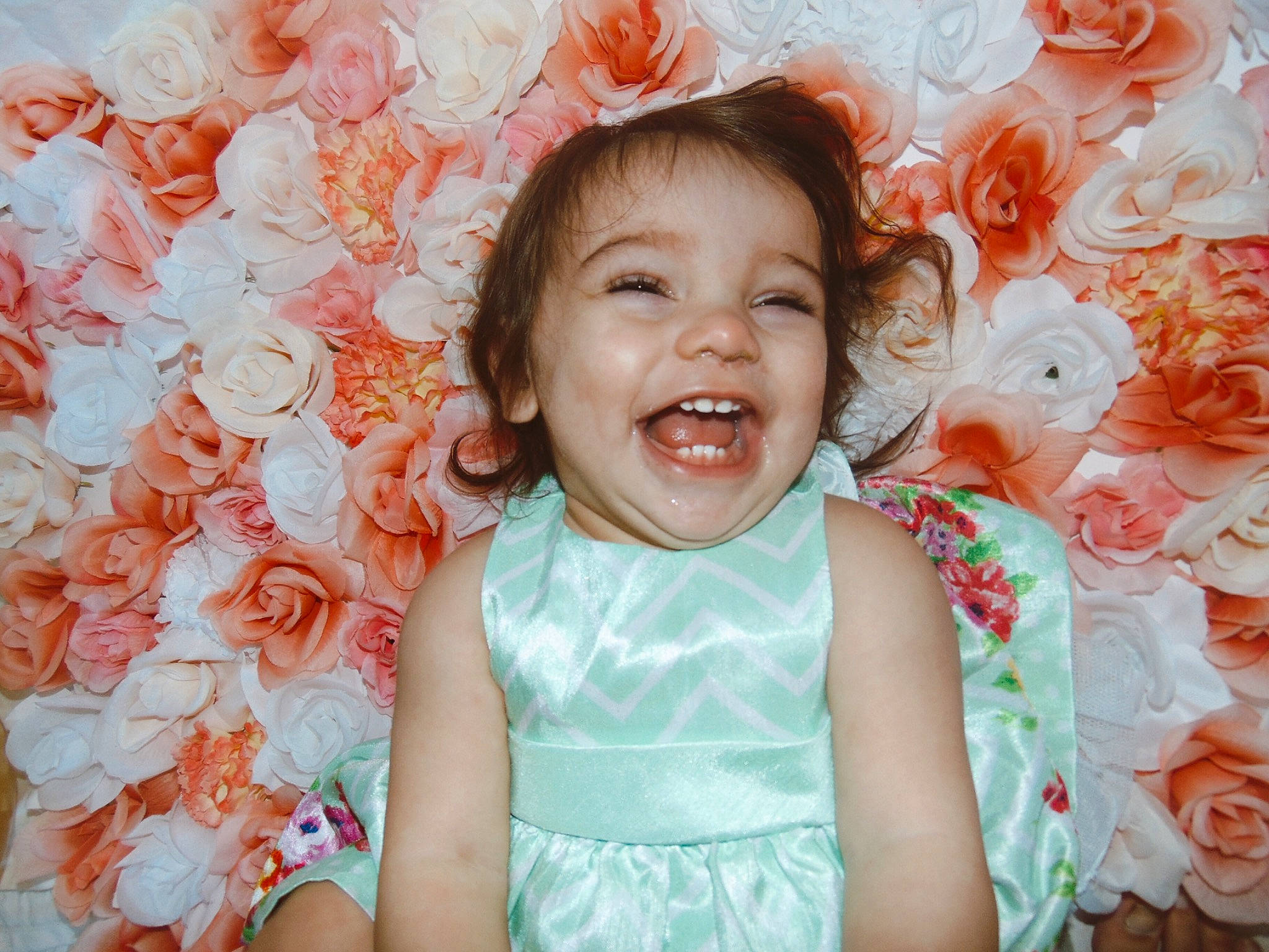 Graylynn is registered to the contest to win money with this photo: baby, cheek, child, child_model, dress, facial_expression, fashion_accessory, flower, happy, iris, laugh, pattern, peach, person, photography, pink, portrait, portrait_photography, smile, textile