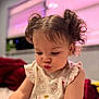 toddler, child, curly_hair, pigtails, indoors, soft_lighting, pink, window_blinds, winnie_the_pooh, clothing, cute, focused, portrait, sitting, baby, earrings, skin, expression, room, background