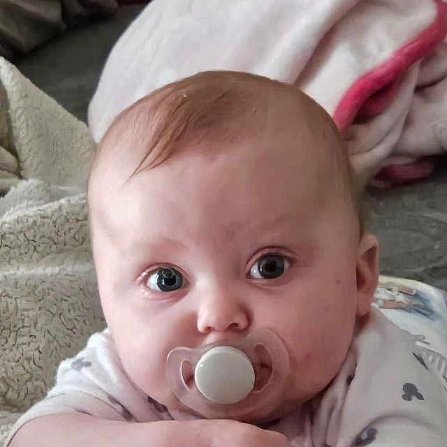 Madelyn joined the competition — help win amazing prizes! baby, biting, blanket, face, head, newborn, person, photography, portrait, spitting