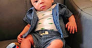 Alaric is registered to the contest to win money with this photo: baby, child, infant, sitting, armchair, leather, portrait, face, eyes, hair, clothing, striped_clothes, shorts, shirt, socks, colorful, indoor, furniture, serious, photography