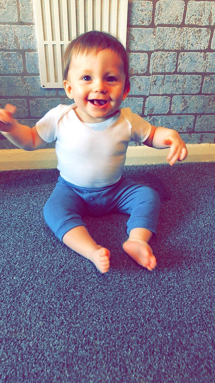 Cason is registered to the contest to win money with this photo: arm, azure, baby_toddler_clothing, cheek, chin, eye, face, facial_expression, floor, flooring, hairstyle, happy, head, joint, joy, leg, organ, person, shoulder, skin