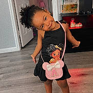 Antonella joined the competition — help win amazing prizes! child, girl, smiling, dress, purse, indoor, floor, fish_tank, television, wooden_floor, black_dress, purple_shoes, curly_hair, door, cabinet, lighting, home_interior, playful, cute, standing