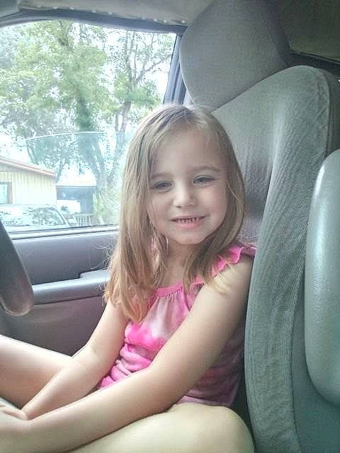 Katelyn is registered to the contest to win money with this photo: auto_part, automotive_design, automotive_exterior, car, car_seat, car_seat_cover, comfort, dress, face, finger, head_restraint, joy, motor_vehicle, person, smile, steering_part, steering_wheel, toddler, tree, vehicle