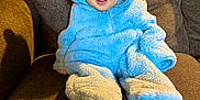 Atticus is registered to the contest to win money with this photo: baby, bonnet, cap, chair, clothing, couch, cushion, face, furniture, hat, head, hood, hoodie, knitwear, person, photography, portrait, sitting, sweater, sweatshirt