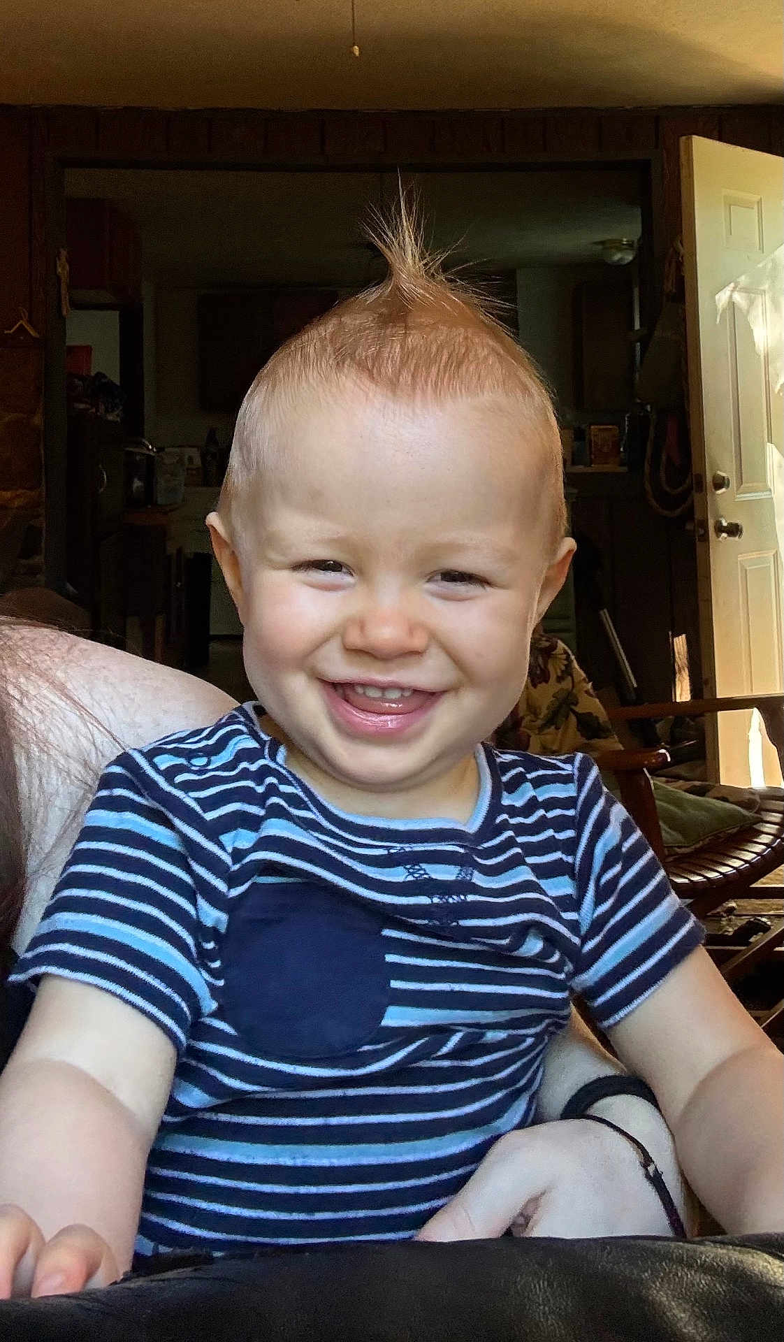 Atticus is registered to the contest to win money with this photo: toddler, child, smiling, indoor, striped_shirt, mohawk, happy, face, person, arm, hand, furniture, door, chair, home, light, room, casual, portrait, skin