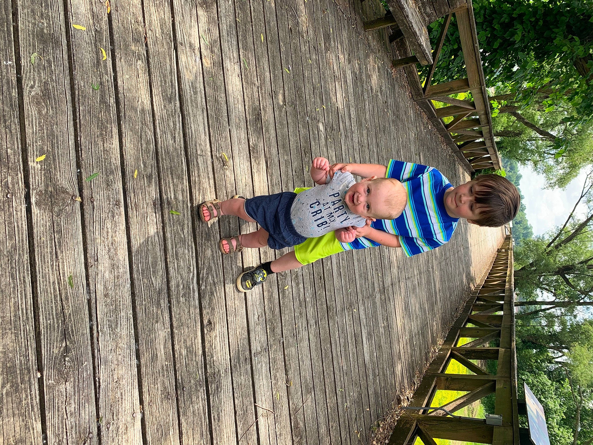 Kolten joined the competition — help win amazing prizes! bridge, child, flooring, fun, grass, hardwood, jungle, leaf, leisure, people_in_nature, person, plant, recreation, rope, t_shirt, toddler, tree, vacation, wood, wood_stain