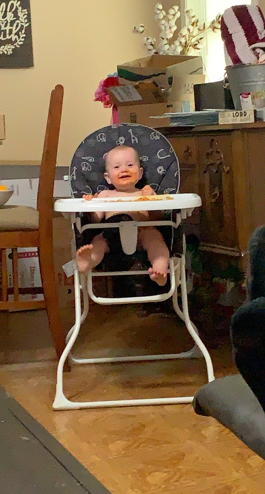 Kolten is registered to the contest to win money with this photo: baby, baby_toddler_clothing, chair, chest_of_drawers, child, comfort, drawer, flooring, furniture, gas, hardwood, helmet, joy, machine, person, room, shorts, sitting, table, thigh