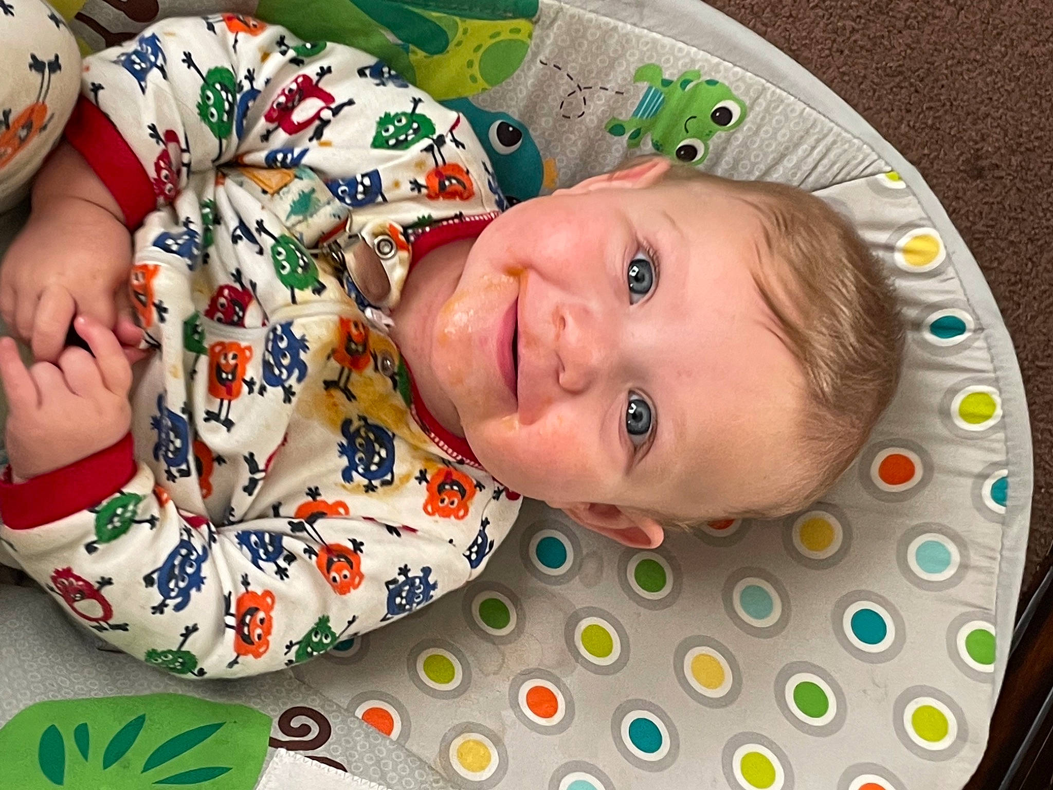 Timothy is registered to the contest to win money with this photo: baby, baby_products, baby_toddler_clothing, carmine, cheek, child, circle, comfort, facial_expression, flooring, fun, happy, iris, linens, pattern, person, skin, sleeve, smile, textile