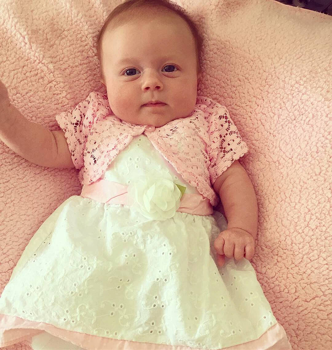 Payslie is registered to the contest to win money with this photo: baby, baby_products, baby_toddler_clothing, cheek, child, clothing, dress, eye, face, head, iris, lace, lip, person, pink, product, skin, smile, toddler