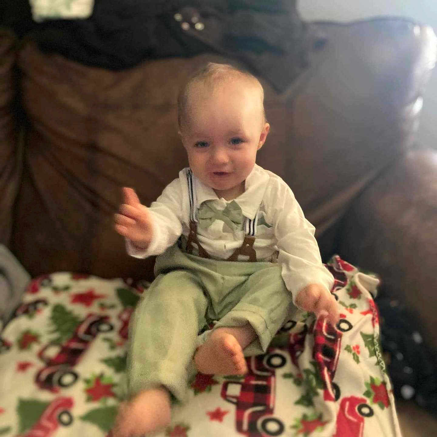 Hudson is registered to the contest to win money with this photo: baby, bed, bodypart, clothing, couch, cushion, face, finger, furniture, hand, happy, head, homedecor, indoors, pants, person, photography, portrait, sitting, t_shirt