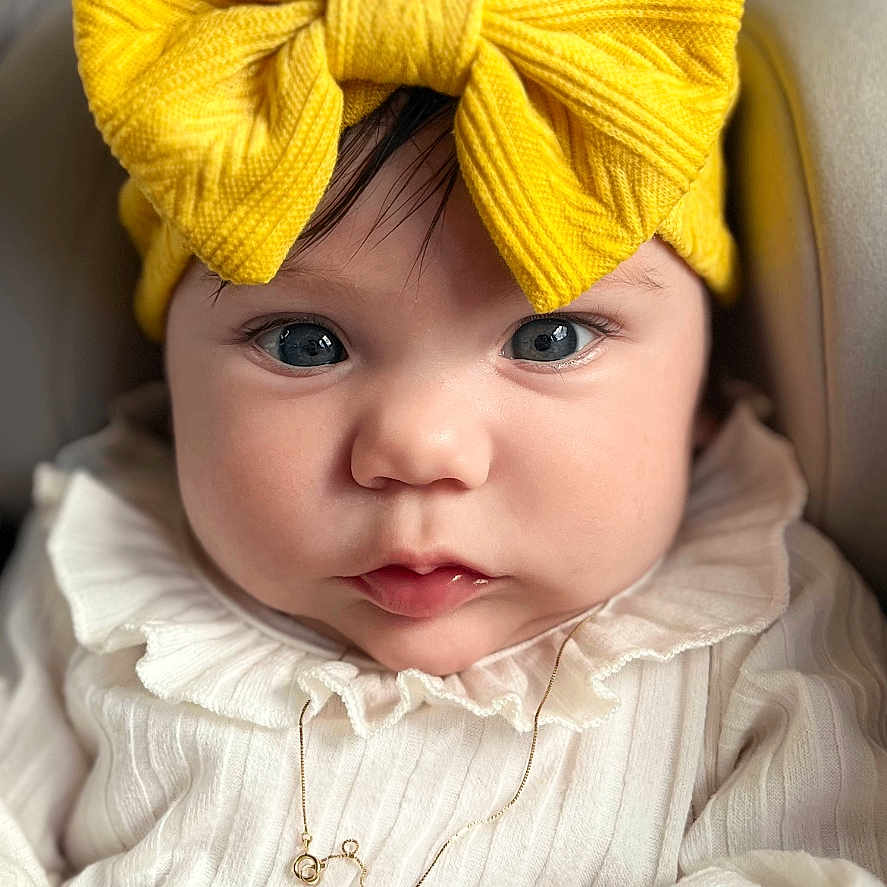 Scarlett is registered to the contest to win money with this photo: accessories, baby, bodypart, bonnet, cap, clothing, face, finger, hand, happy, hat, head, jewelry, necklace, newborn, person, photography, portrait, smile, turban