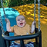 baby, blue, child, colorful, fence, happy, open_mouth, outdoor, park, playground, playground_surface, seated, smiling, striped_shorts, sunlight, swing, swing_chains, toddler, trees, yellow