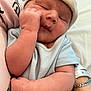 newborn, baby, sleeping, infant, hat, blue_clothing, arm, hand, adult_arm, bracelet, pink_shirt, closeup, skin, resting, cute, peaceful, person, indoor, portrait, cozy
