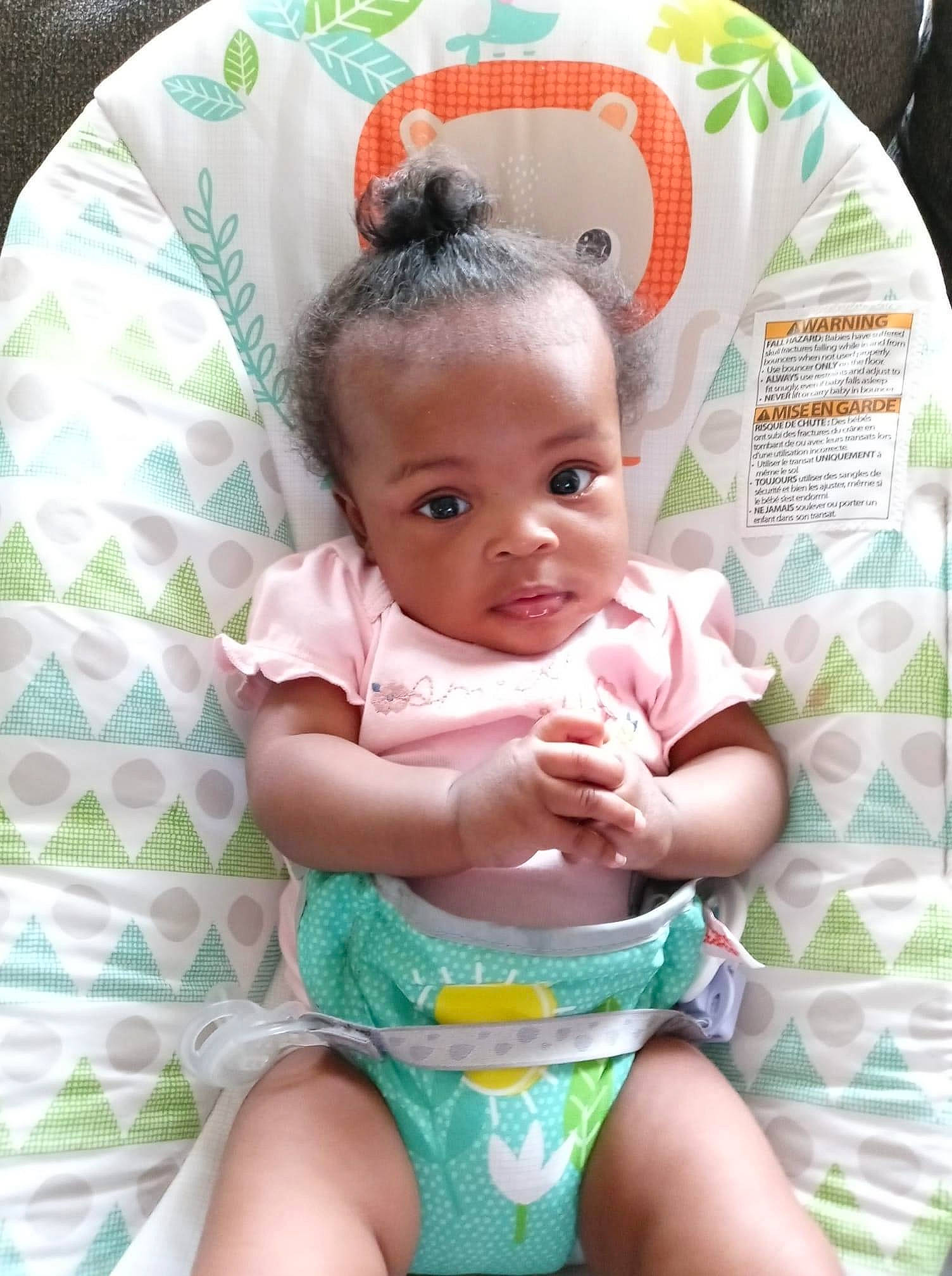 Janiya is registered to the contest to win money with this photo: abdomen, baby, baby_toddler_clothing, cheek, chest, child, comfort, grass, happy, head, organ, person, pink, product, skin, smile, stomach, thigh, thumb, toddler