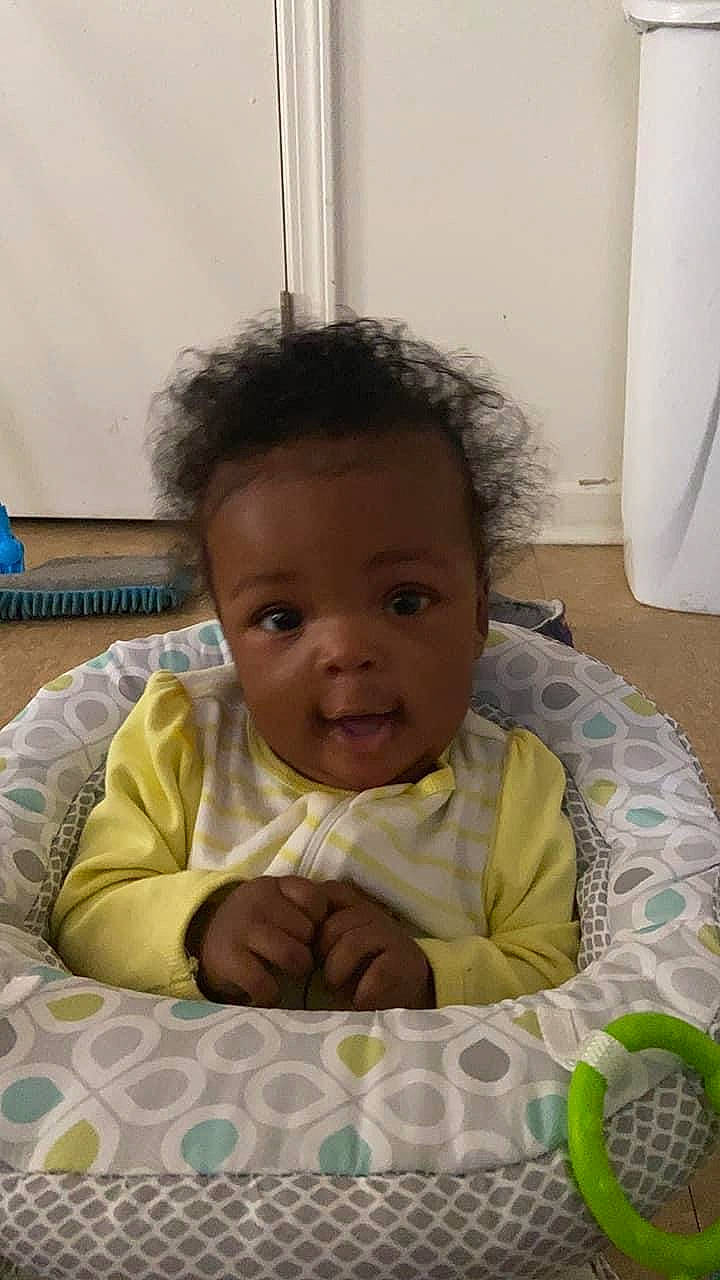 Janiya is registered to the contest to win money with this photo: baby, baby_toddler_clothing, cheek, child, comfort, eyebrow, eyelash, face, fun, happy, head, iris, linens, lip, mouth, nose, person, sitting, skin, smile