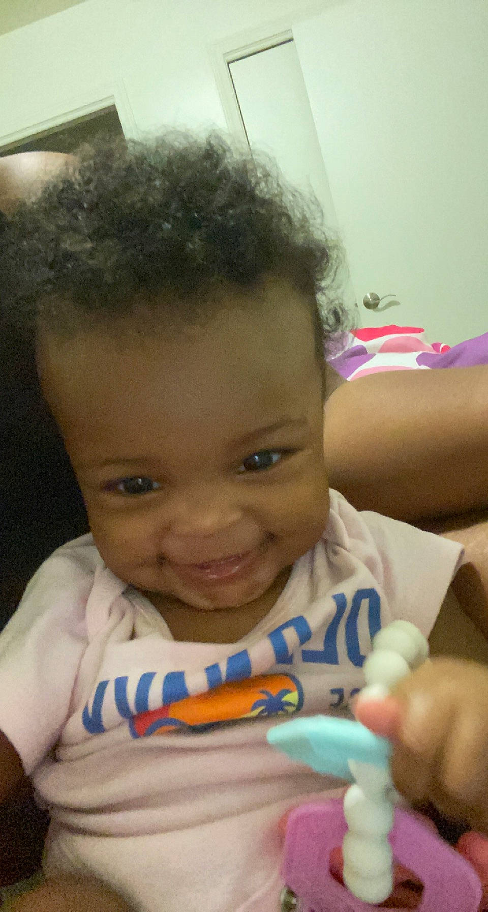 Janiya is registered to the contest to win money with this photo: arm, baby, cheek, ear, eye, eyebrow, face, facial_expression, forehead, hairstyle, hand, happy, human, iris, joy, lip, mouth, nose, organ, person